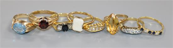 Eight assorted gold and gem set rings- 18ct(4) and 9ct(4).